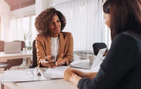 An interviewer and applicant talk during a second interview.