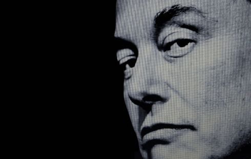 A black and white photo of tech mogul Elon Musk, who owns SpaceX, Tesla, Neuralink and other companies.
