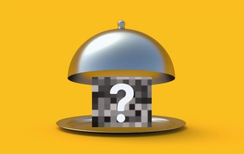 An open cloche revealing a pixelated box with a question mark over it.