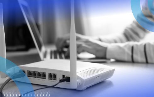 A picture of a cable modem next to a laptop.
