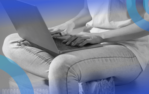 A software engineer works with a laptop on their lap