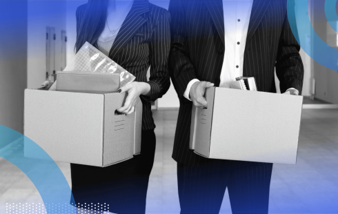 Two office workers carry boxes of belongings after being fired