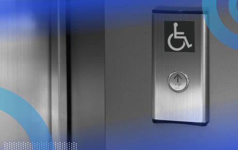 A silver elevator button with the accessibility symbol above it