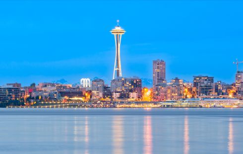 A photo of the Seattle skyline from the water at dusk.