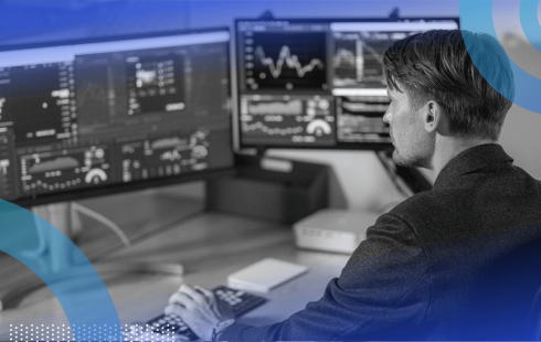 A white collar worker uses multiple screens to multitask