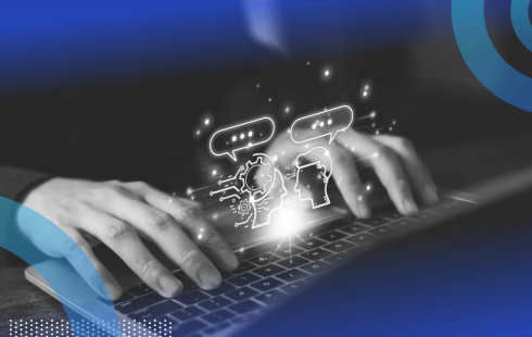 A closeup on a pair of hands on a laptop with two animated heads talking