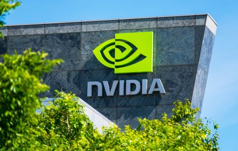 Granite building facade with the Nvidia logo in green, partially blocked by a green tree.