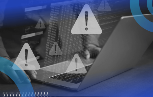 A closeup of hands working on a laptop with warning icon overlays