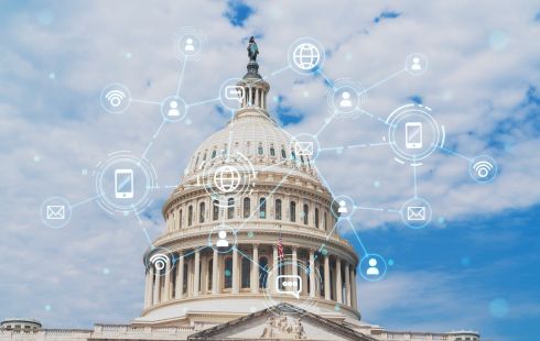 A state capitol building is overlayed with images of smartphones and other technological symbols.