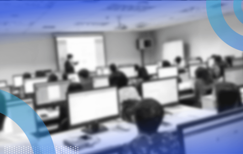 A group of people take a training class on computers
