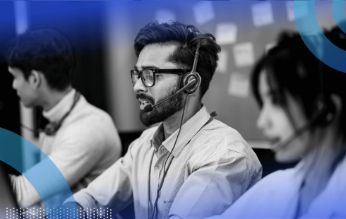 A software engineer in front of a kanban board speaks on a headset