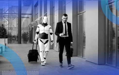 A man in a suit on the street looks at a smartphone while a robot with a suitcase follows him