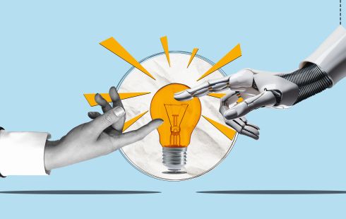 A human finger and a robotic finger touch opposite ends of a lightbulb.