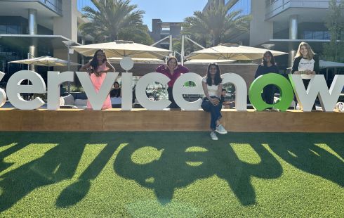 ServiceNow interns pose next to the sign outside.