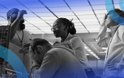 A group of employees argue around a computer