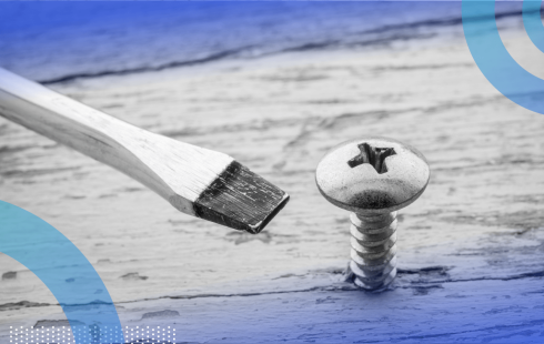 A flathead screwdriver next to a Phillips-head screw