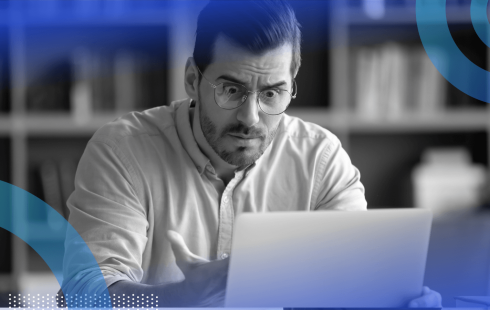 A man looks extremely frustrated while using a tablet computer