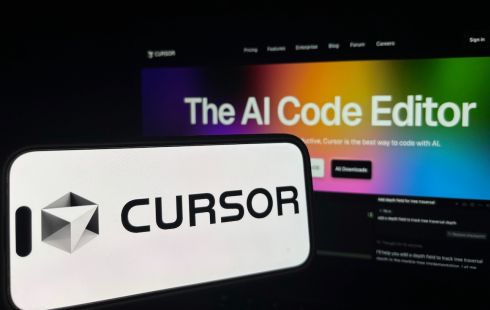 The Cursor logo is shown on a smartphone in front of a laptop.