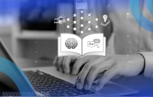 A closeup of hands typing on a laptop with a glowing book with AI concepts above it