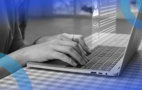 Hands typing on a laptop