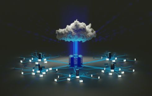 A cloud floats over a server connected to computers.