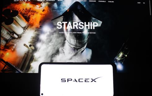 A rocket takes off, with the Starship and SpaceX word logos positioned in front of the image.
