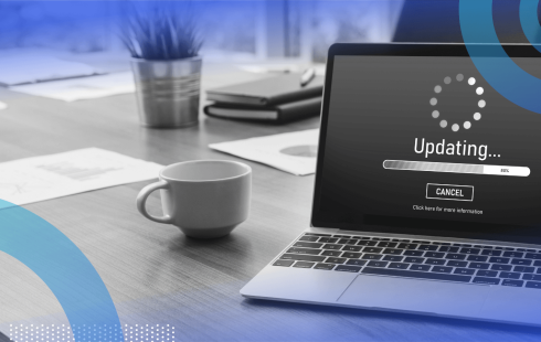 A laptop showing a software update with a coffee cup nearby