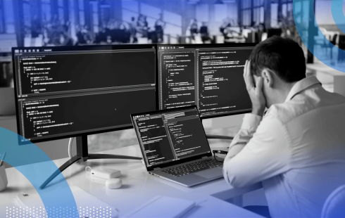 A software engineer looks frustrated while reviewing code