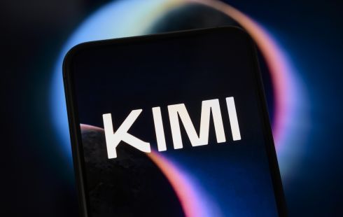 The Kimi logo displayed on a black phone screen, with a black background illuminated by a purple light.