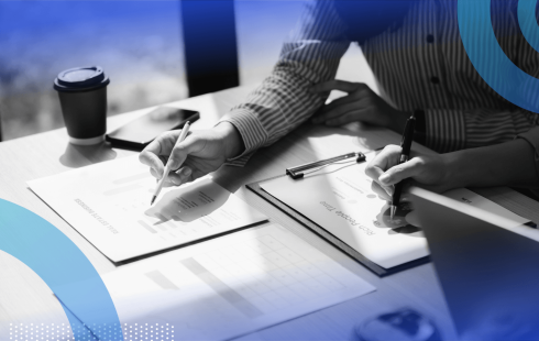 Two people work on documents