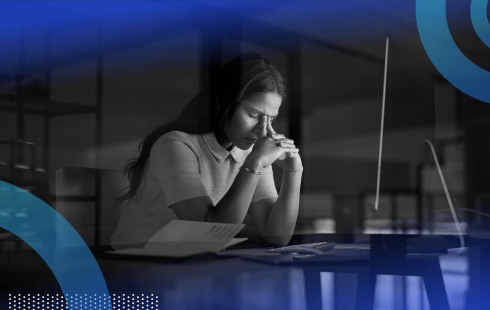 A woman looks frustrated at a computer