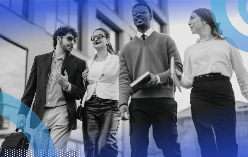 A group of four young professionals walk together