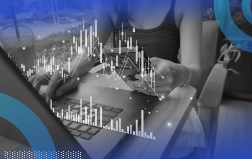 A woman looks at financial data on her phone and laptop