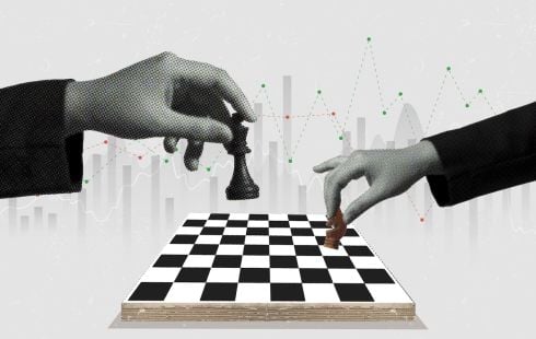 Two hands move pieces on a chess board.