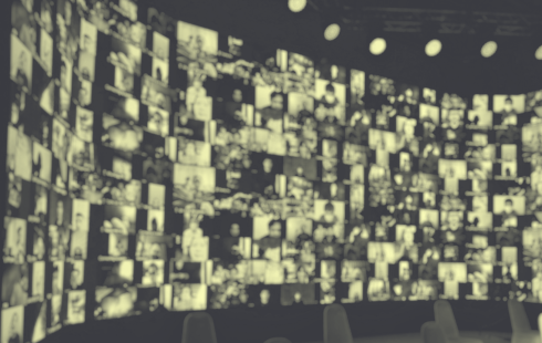 Blurred faces on a large screen for a large online event.
