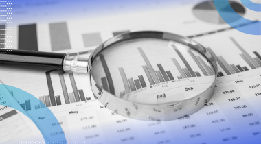Inferential statistics image of a magnifying glass sitting on top of a bar graph