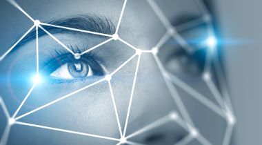 Virtual data points overlay a person's face to represent facial recognition technology.