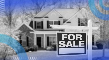 A for sale sign in front of a two-story house.