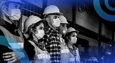 Five people in a row wearing PPE.