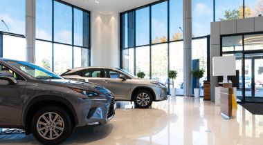 The interior of a car dealership is shown.