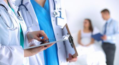 A photo of doctors conversing is shown.