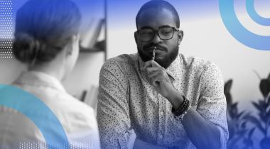 A doubtful man questioning a colleague.