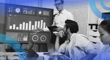 Team reviewing data analysis reports on a monitor