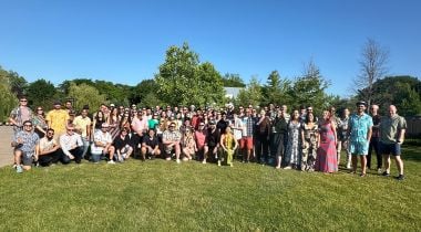 The Roofr team poses for a group photo outdoors.