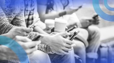 people on a bench watching digital content on their phones