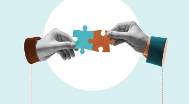 An image of hands combining puzzle pieces to show connection. 