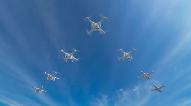 A group of drones flying in the sky