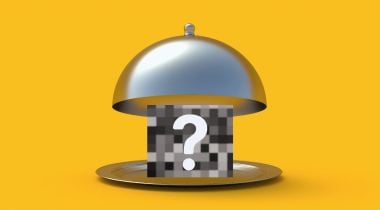 An open cloche revealing a pixelated box with a question mark over it.