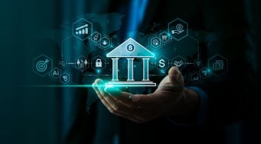 The image of a bank is held in someone's hand.