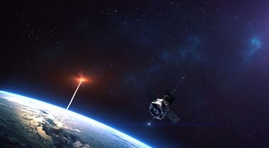 A glowing red object bursts out of the Earth's atmosphere and into space.